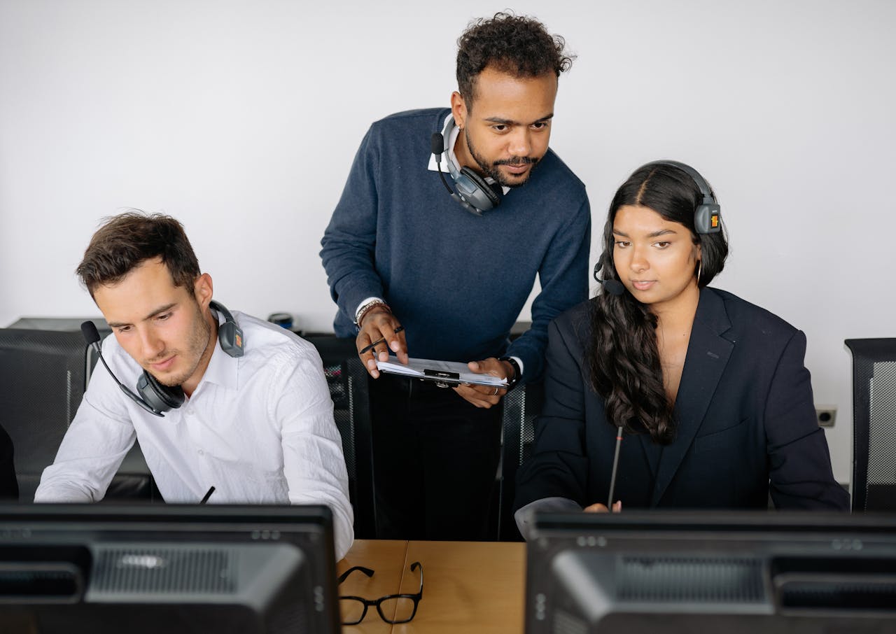 Man and Woman Looking at the Screen of a Computer